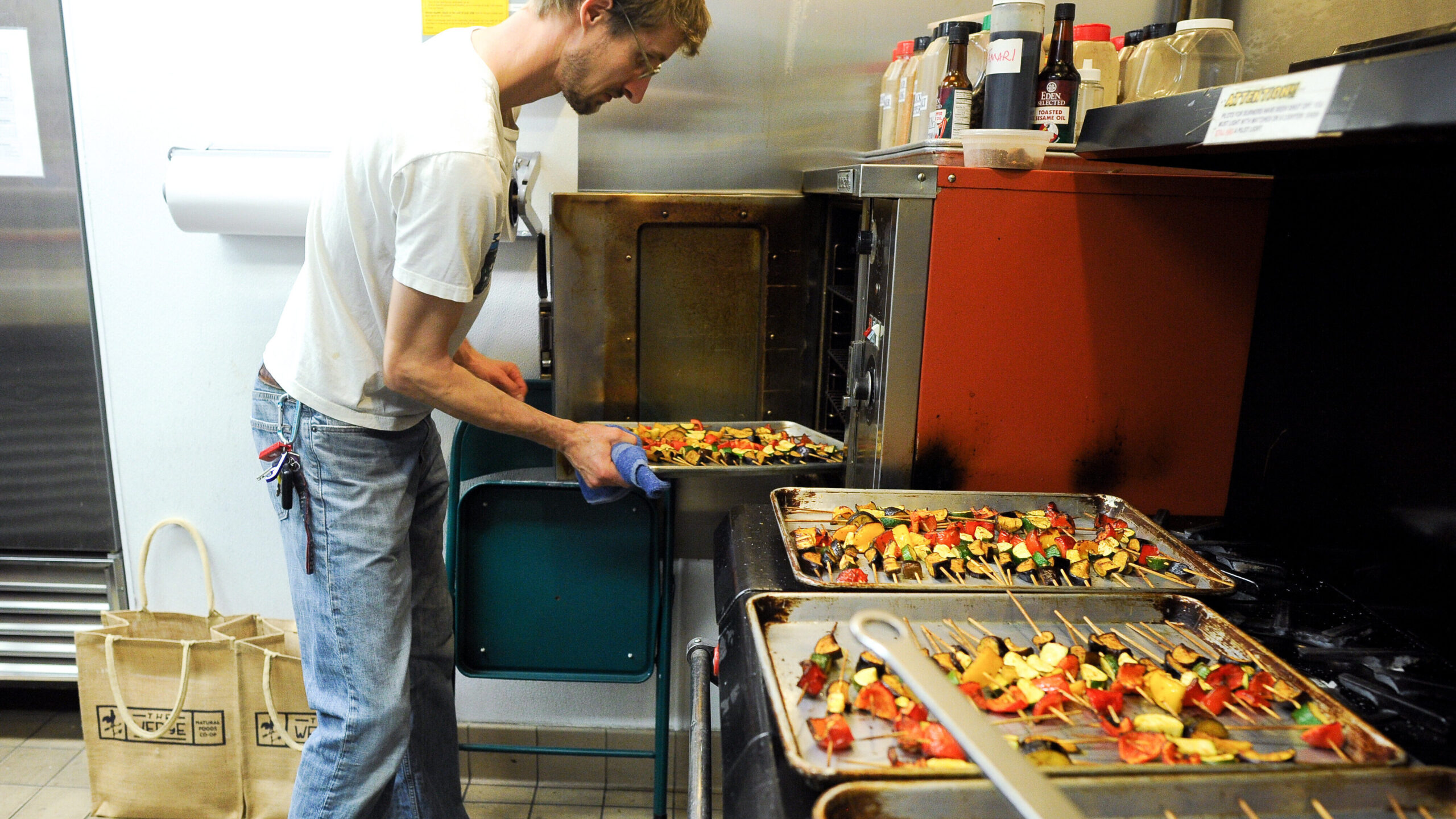 Nick Schneider prepares roasted vegetable skewers for The Return of King Idomeneo: A Picnic Operetta, 2012